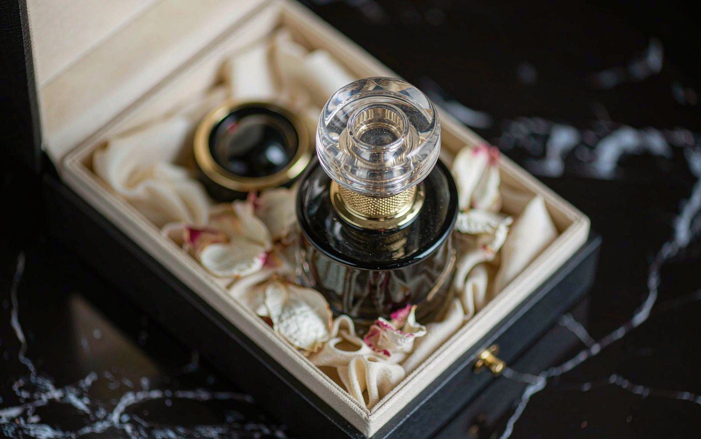 Premium perfume bottle in a black gift box, styled as an autumn gift